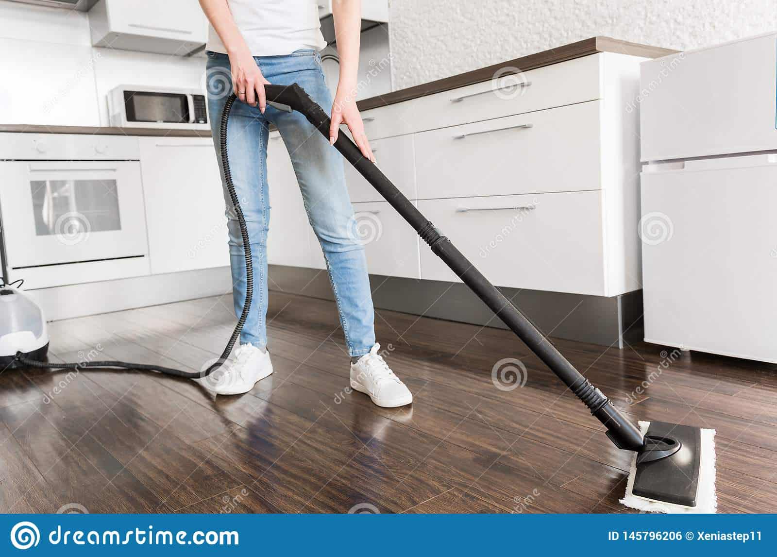 professional home cleaning service woman washes floor steam mop 145796206