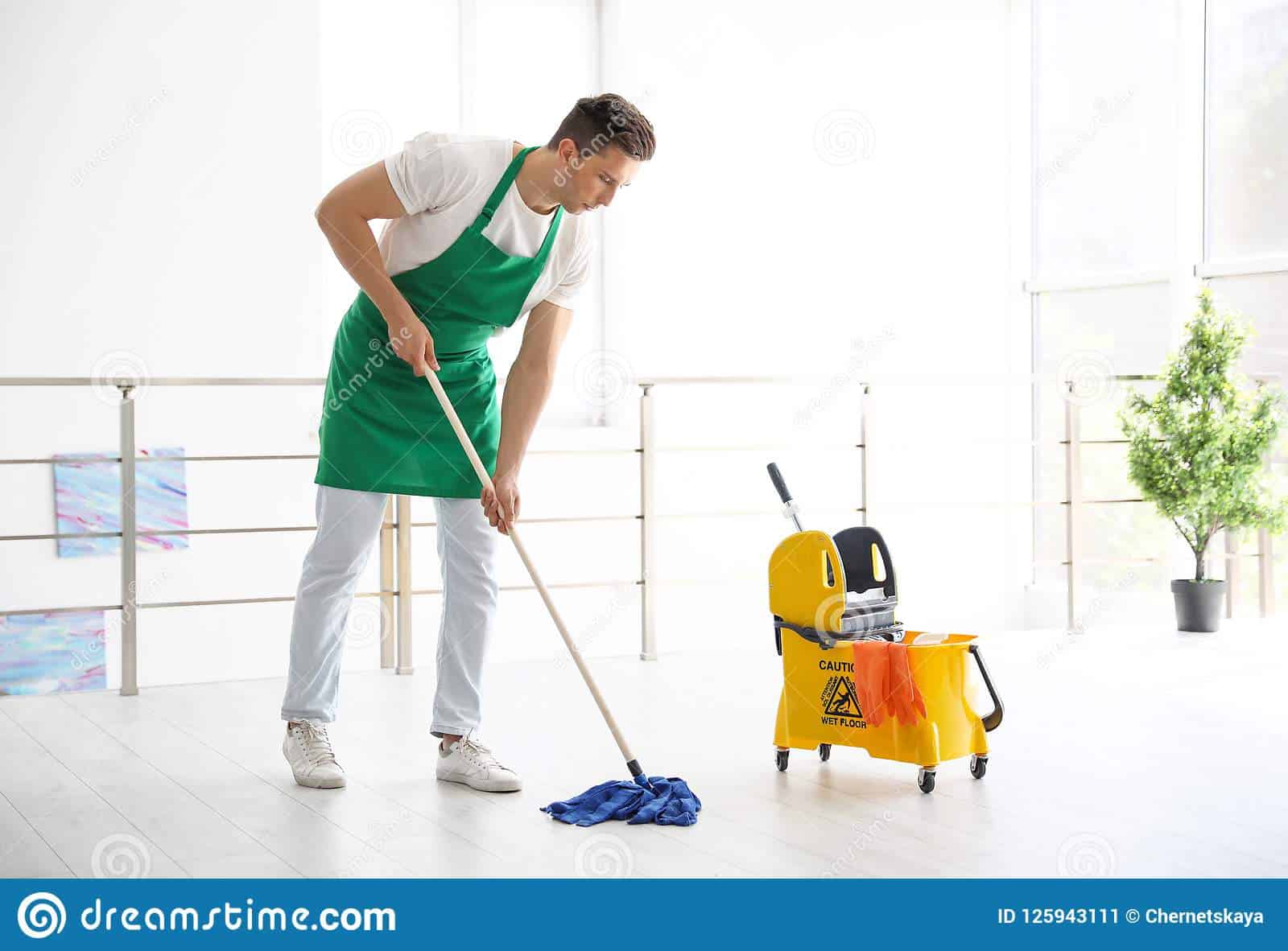 young man mop cleaning floor indoors 125943111